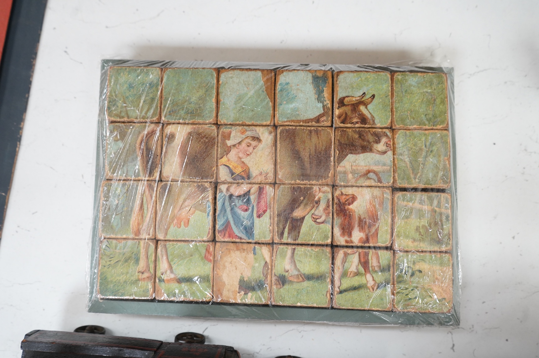 A painted wooden pull a long toy train-48cm long and two carriages, together with a painted wooden block puzzle